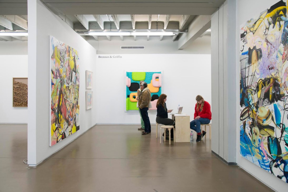 Gallery visitors viewing colorful artworks at Independent Brussels 2016 in the Vanderborght Building.