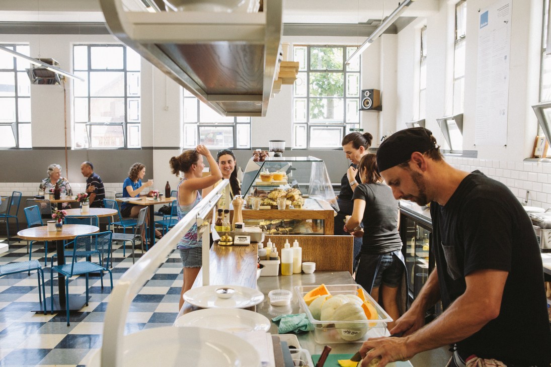 Staff prepare food at the open kitchen counter at Kokako café in Auckland's Grey Lynn neighbourhood.