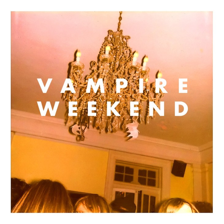 Vampire Weekend album cover featuring ornate gold chandelier with lit candles against warm peachy-orange interior walls.
