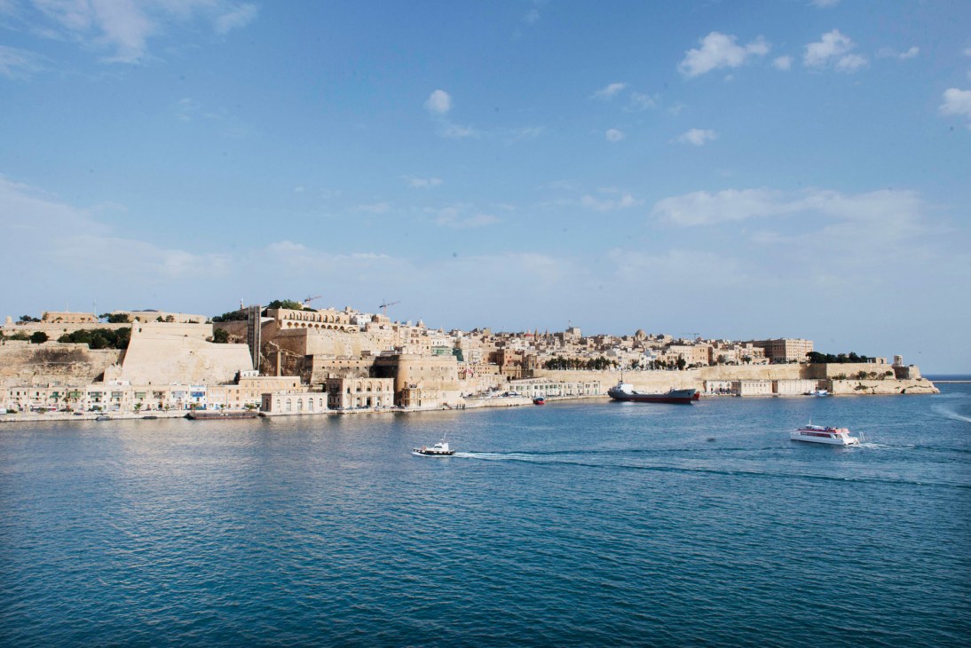 Valletta's waterfront with historic limestone buildings and fortifications overlooking the Grand Harbour.