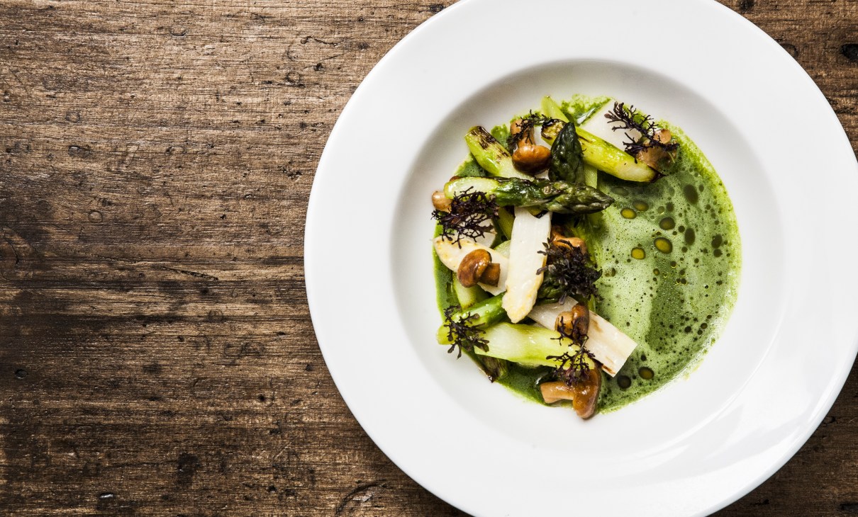 Plated dish with roasted vegetables, mushrooms and green sauce at Wassail, New York