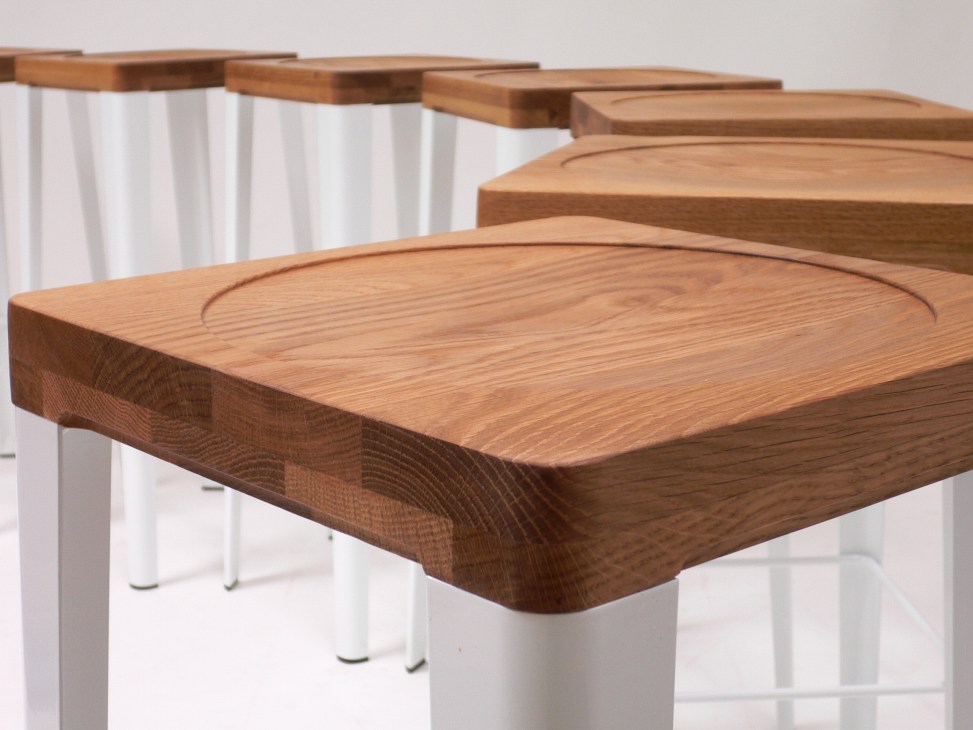Yellow Diva's WB Series wooden stools with white legs arranged in a row.