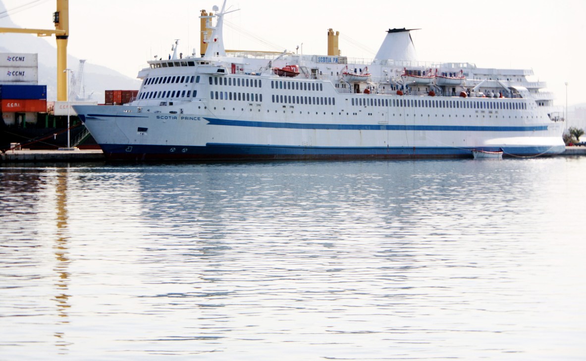 Scotia Prince passenger ferry docked at port with cargo containers visible alongside.