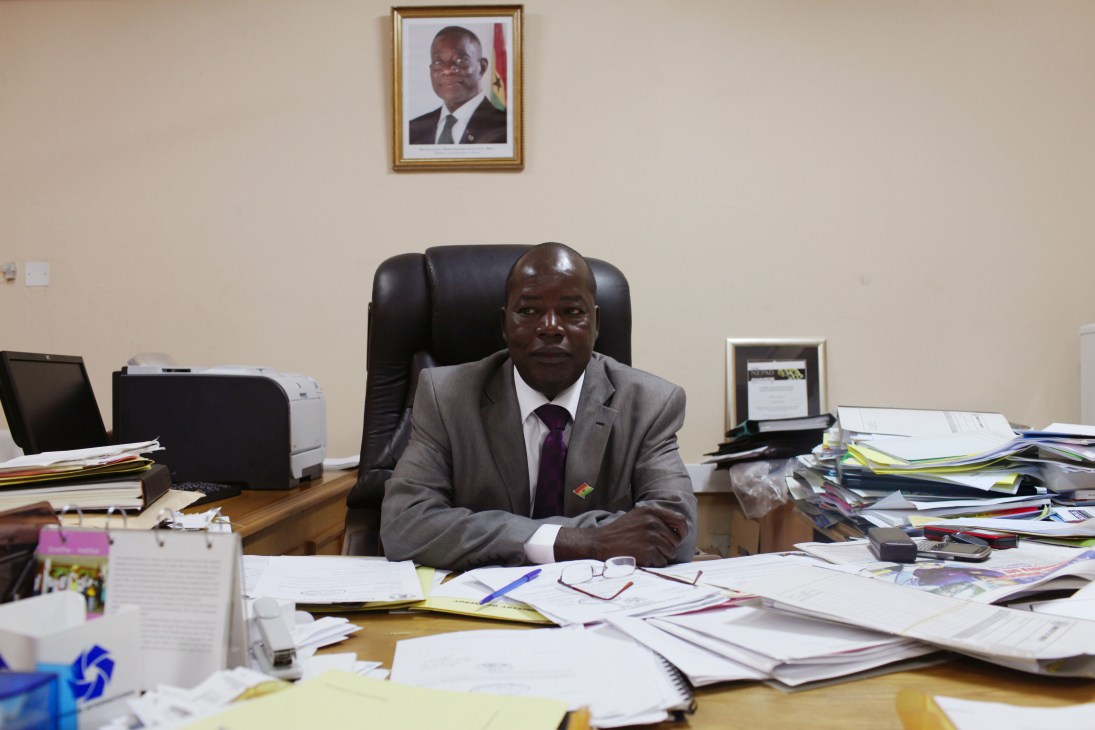 Thomas Akabzaa, chief director of Ghana's Ministry of Energy, seated at his desk in his office.