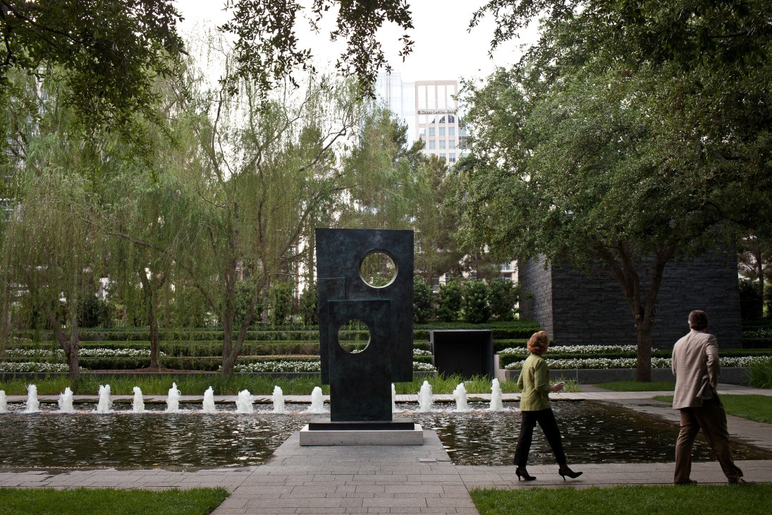 Barbara Hepworth bronze sculpture with circular voids in the Nasher Sculpture Center garden.