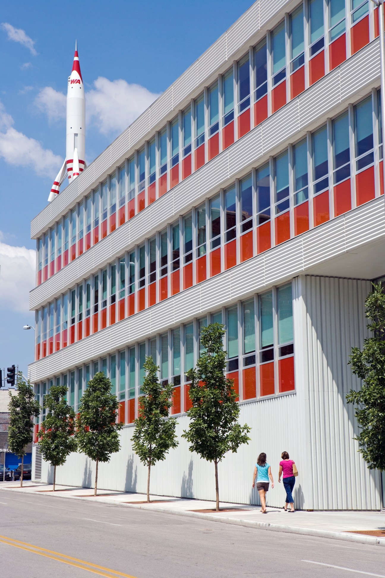 Historic TWA headquarters building in Crossroads with colorful facade and vintage rocket sculpture.