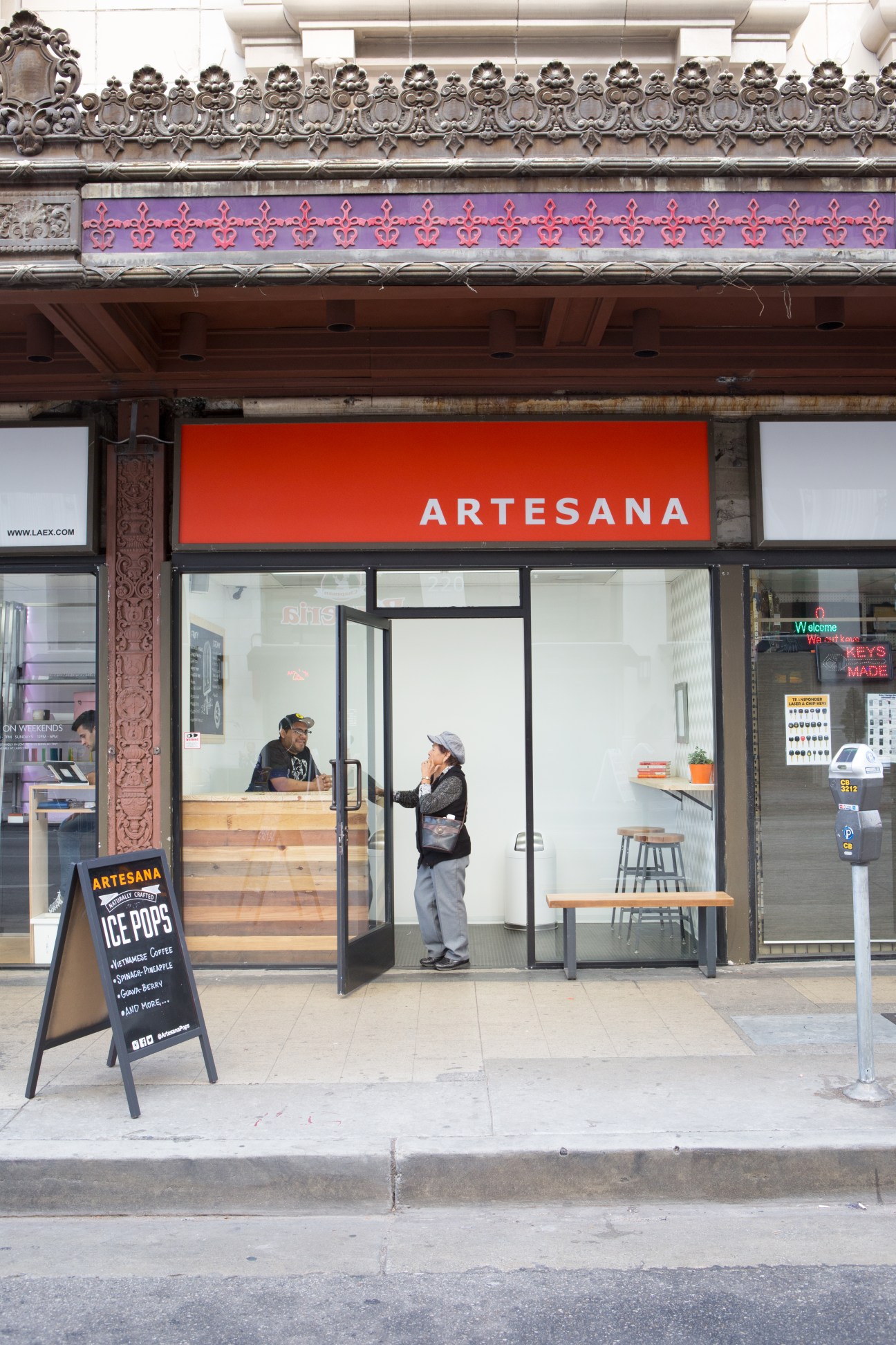 Artesana ice lolly shop storefront in Los Angeles with ornate theater facade above.