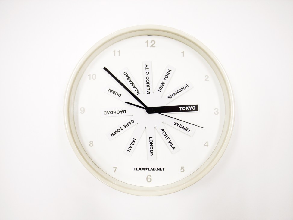Team Lab world clock with city names radiating from center and Tokyo highlighted on the hand.