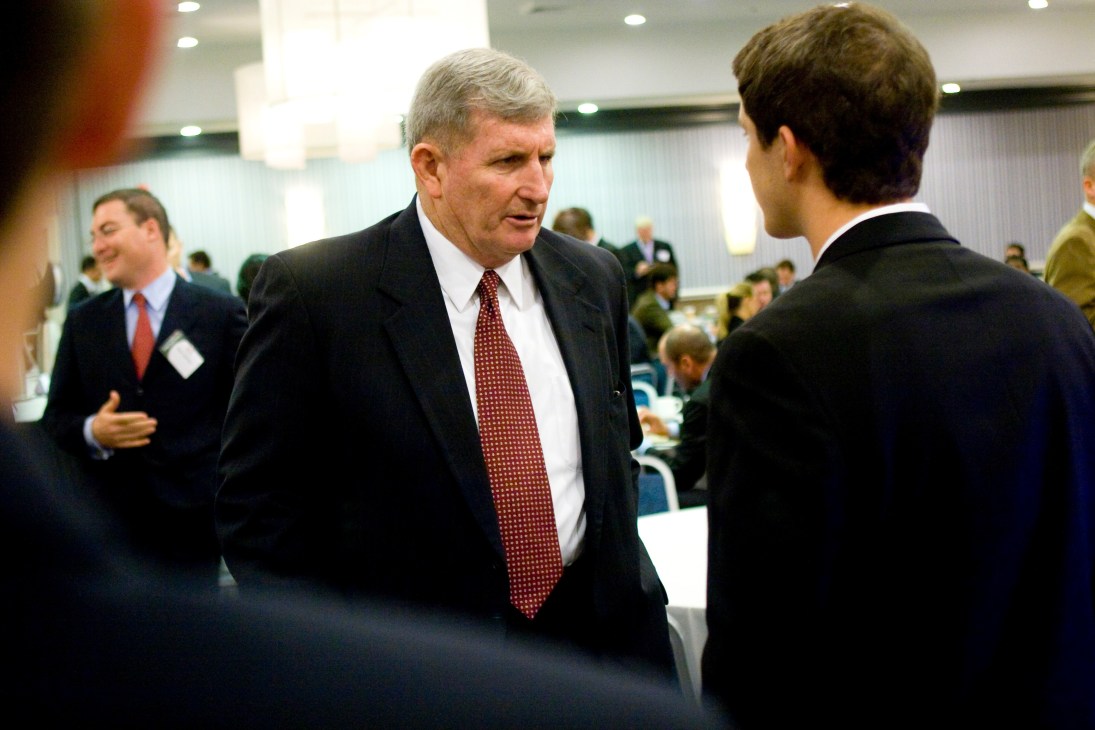 General Peter Schoomaker, former chief of staff of the US Army, speaks with attendees at a private military contractor conference.