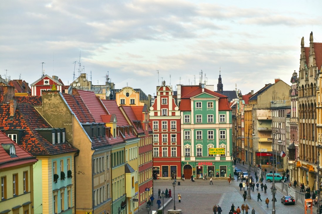 Wroclaw's historic market square with colorful Renaissance buildings and red-tiled roofs.
