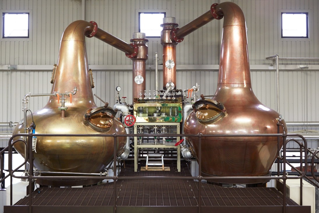 Copper pot and spirit stills with red piping at Chichibu Distillery, custom-made by Forsyths in Scotland.