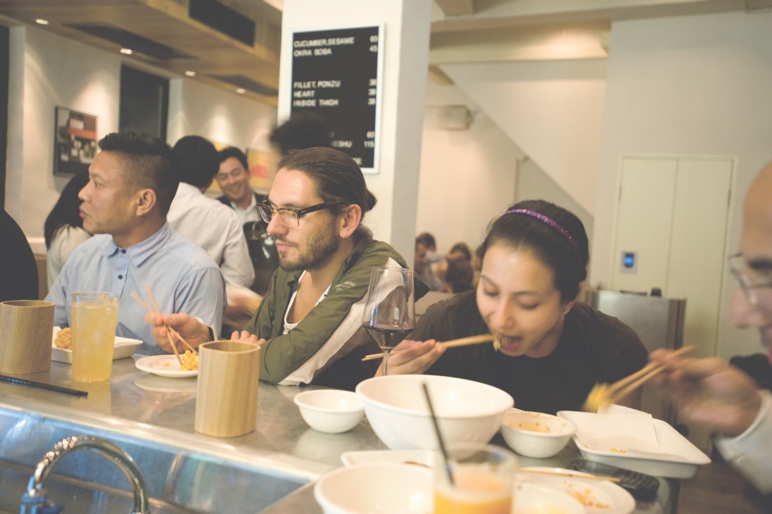 Diners eating yakitori at Yardbird restaurant counter in Hong Kong's Sheung Wan neighbourhood.