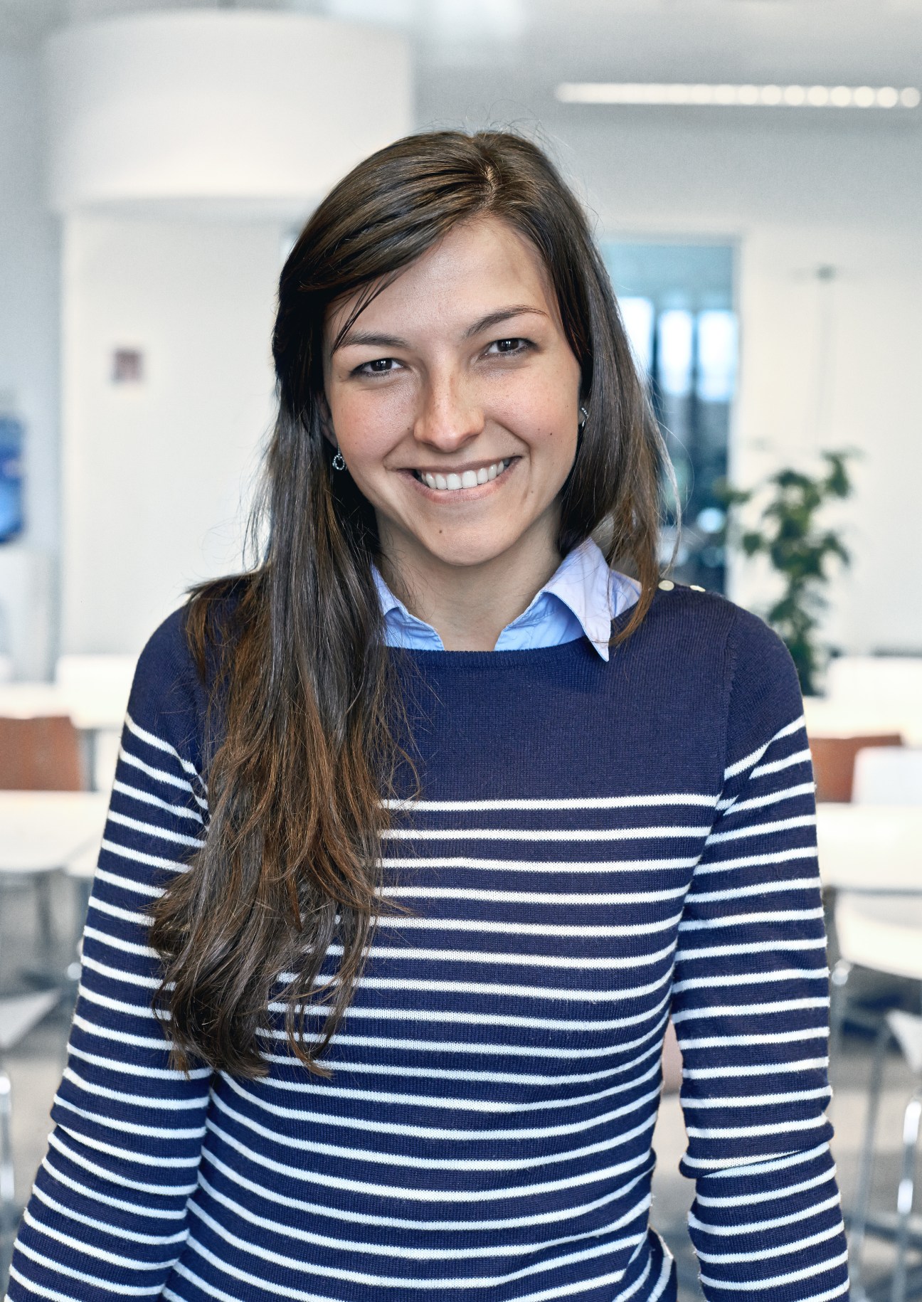 Scarlett Varga, partnerships coordinator at Bruegel, smiling at camera in modern office setting.